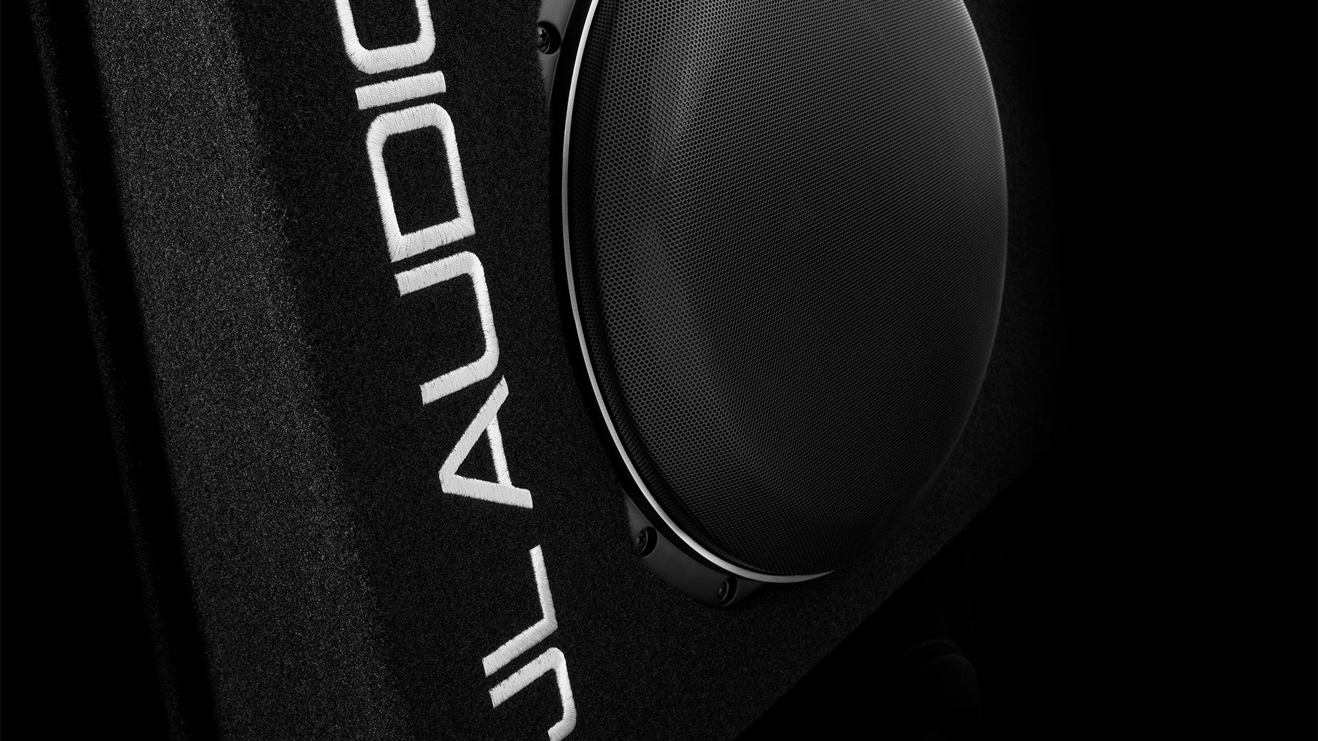 A closeup view of a PowerWedge CS113TG TW5v2 enclosed car subwoofer unit.