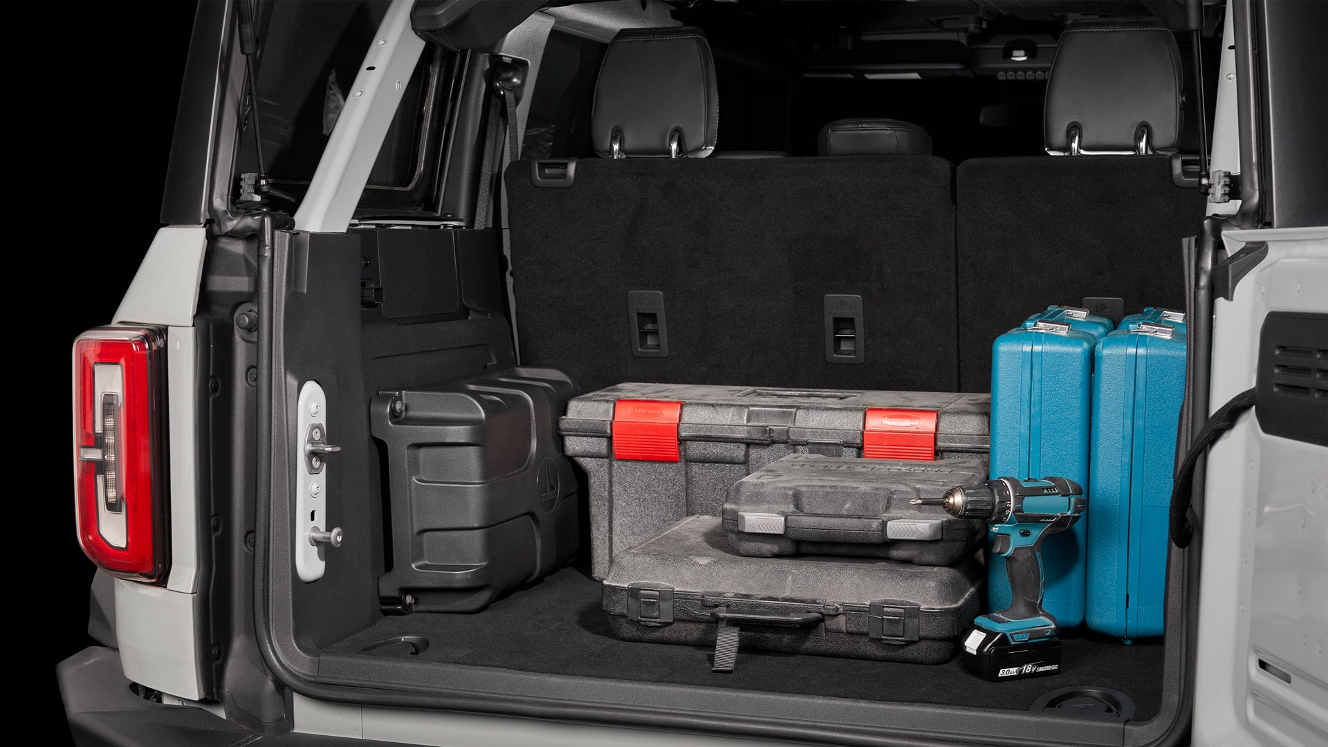 StowAway enclosure installed in the back of an SUV, surrounded by work tools