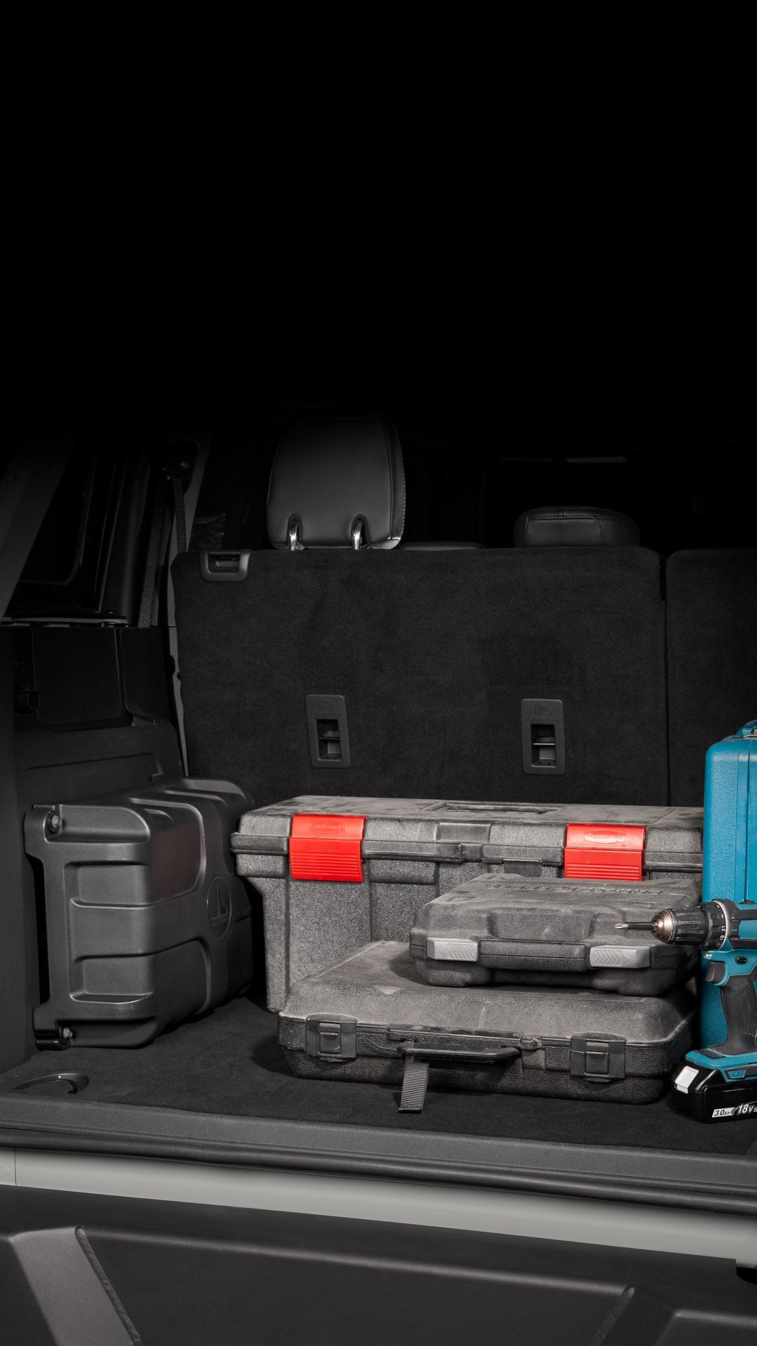 StowAway enclosure installed in the back of an SUV, surrounded by work tools